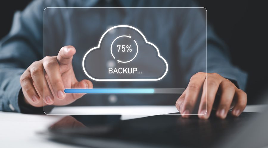Hands interacting with holographic cloud backup progress bar — automated, secure, and continuous data backups powered by McNallan Technology for MN enterprises