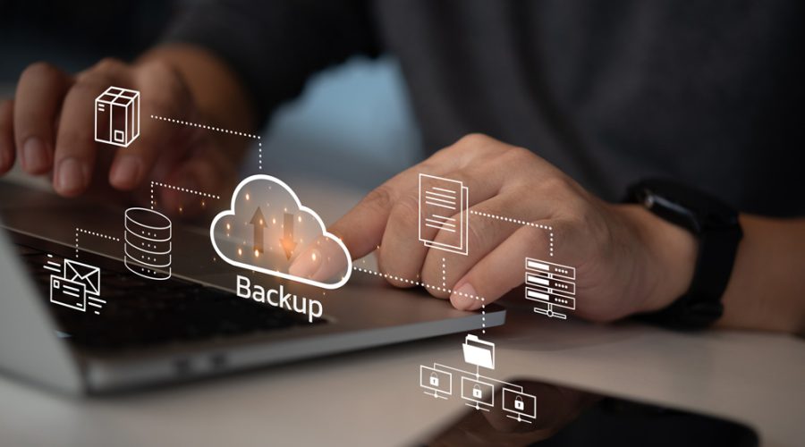 User interacting with “Backup” cloud icon surrounded by server, email, and file icons — end-to-end data protection strategy for Twin Cities businesses by McNallan Technology