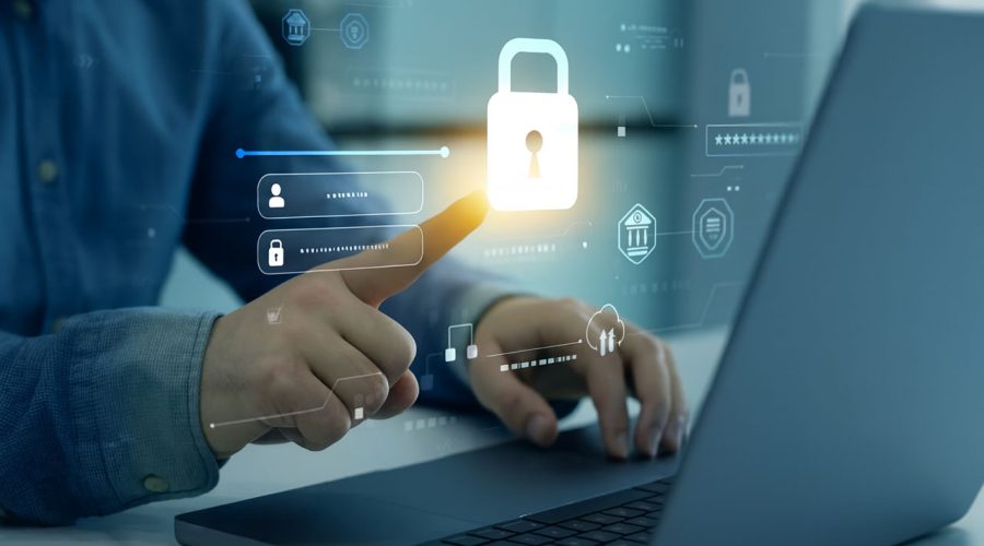 User tapping glowing padlock icon on laptop screen — multi-factor authentication, secure access, and identity protection services by McNallan Technology for MN businesses