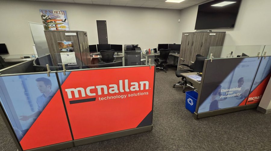 Reception area with branded “McNallan Technology Solutions” partitions and modern workstations — welcoming, professional environment for client consultations in MN